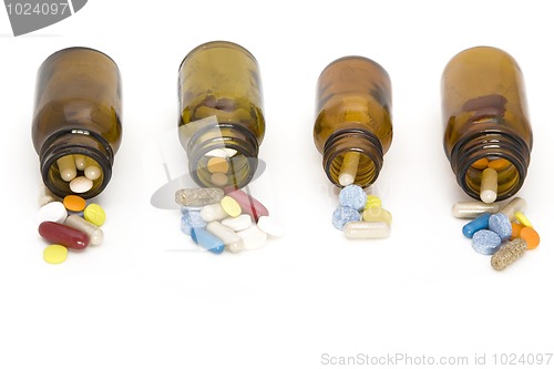 Image of colored stream of pills coming from a pill bottles