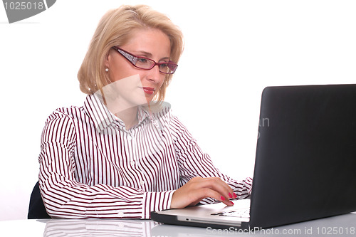 Image of young business woman using laptop at work desk 