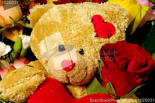 Image of Teddy bear and roses