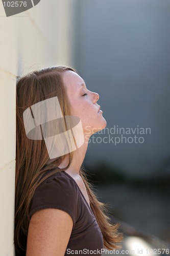 Image of girl leaning against wall