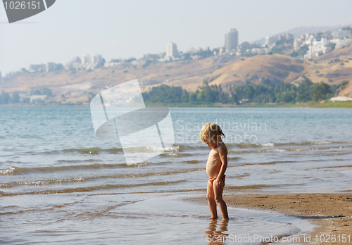 Image of Child on the shore of lake Kinneret in the morning