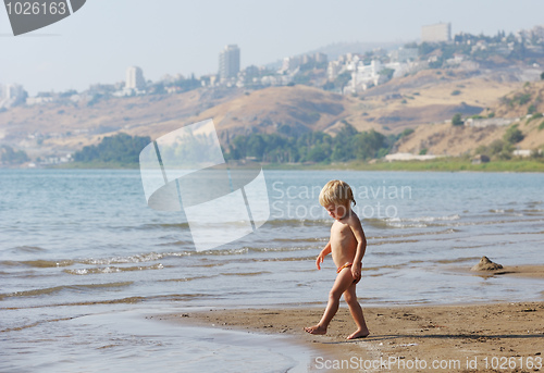 Image of Child on the shore of lake Kinneret in the morning