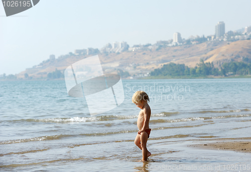 Image of Child on the shore of lake Kinneret in the morning