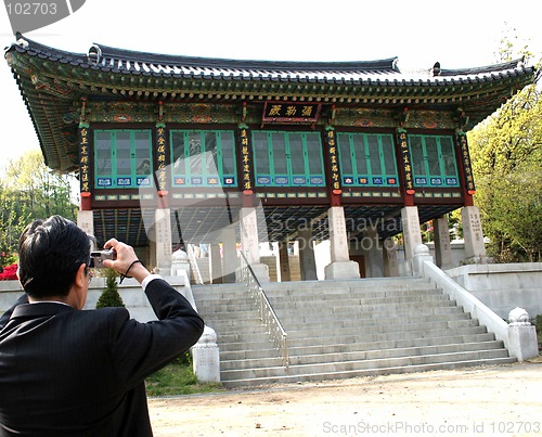 Image of Businessman stops for a photo