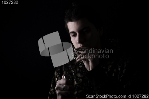 Image of portrait of a young man with cigarette 