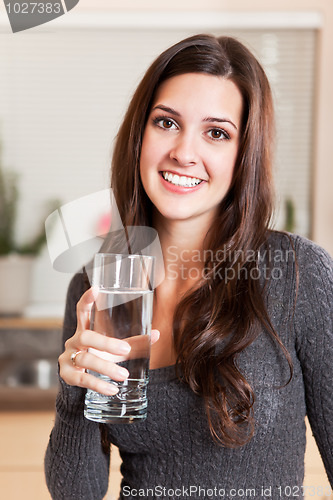 Image of Woman holding glass of water