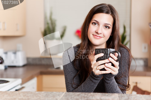 Image of Woman holding coffee cup