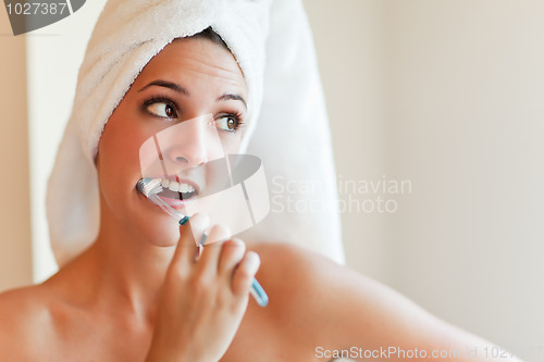 Image of Woman brushing teeth
