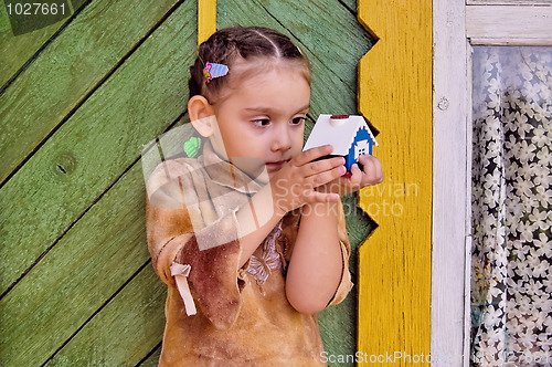 Image of Girl with toy house