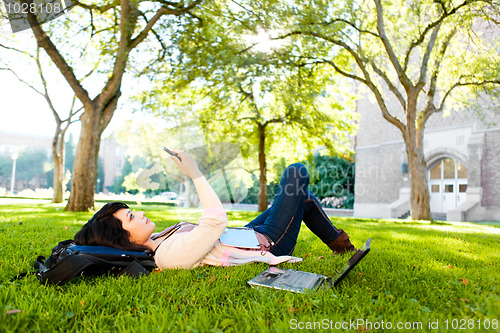 Image of Mixed race student texting