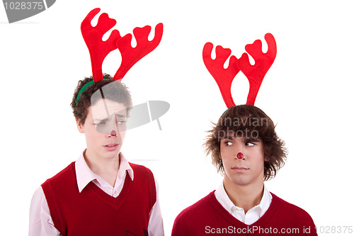 Image of happy young men wearing reindeer horns, admired, on white, studio shot