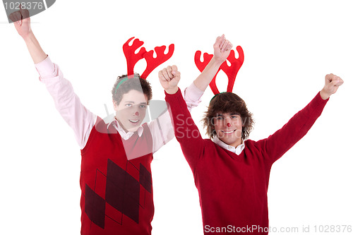 Image of happy young men wearing reindeer horns, with arms raised, on white, studio shot
