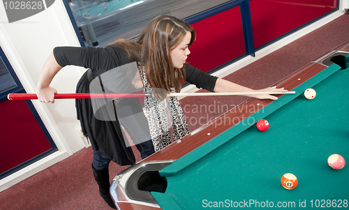 Image of Woman playing pool