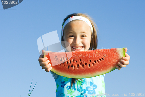 Image of Girl showing a watermelon slice