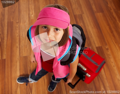 Image of Little girl with luggage