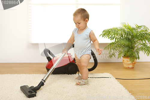 Image of Baby boy with vacuum cleaner