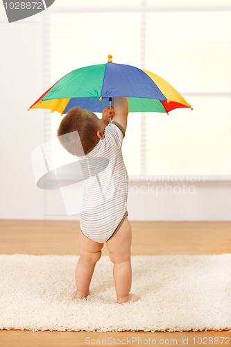 Image of Baby boy opening the umbrella
