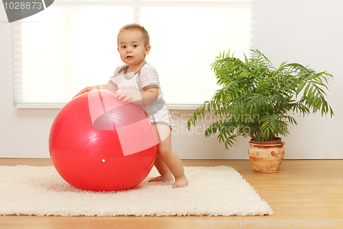 Image of Baby boy with big red ball