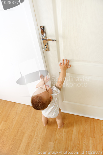 Image of Baby in front of door