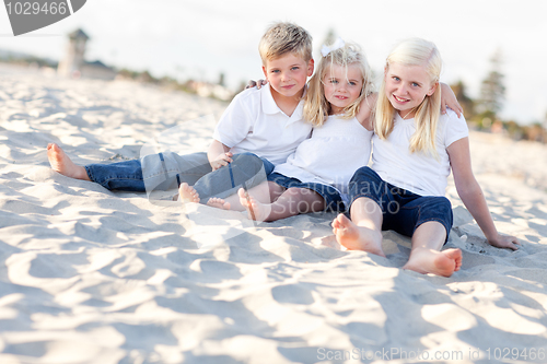Image of Adorable Sisters and Brother Having Fun at the Beach