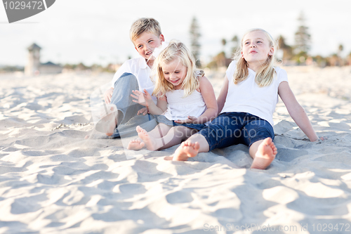 Image of Adorable Sisters and Brother Having Fun at the Beach