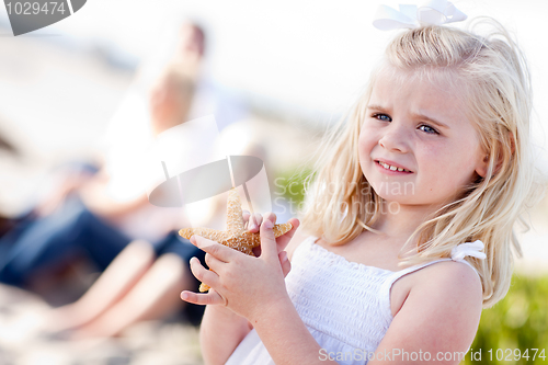 Image of Adorable Little Blonde Girl with Starfish