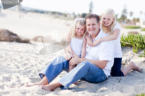 Image of Handsome Dad and His Cute Daughters at The Beach