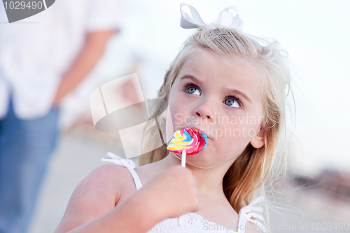 Image of Adorable Little Girl Enjoying Her Lollipop Outside