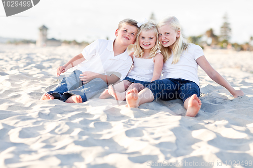 Image of Adorable Sisters and Brother Having Fun at the Beach