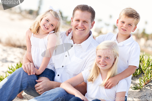Image of Handsome Dad and His Cute Children at The Beach