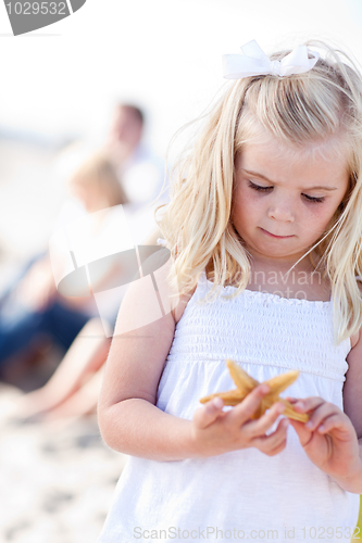 Image of Adorable Little Blonde Girl with Starfish