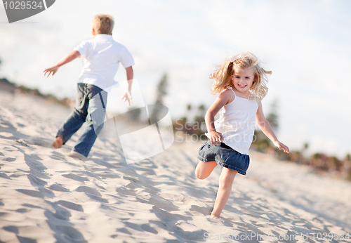 Image of Adorable Brother and Sister Having Fun at the Beach