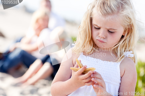 Image of Adorable Little Blonde Girl with Starfish