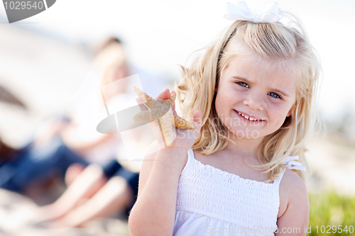 Image of Adorable Little Blonde Girl with Starfish