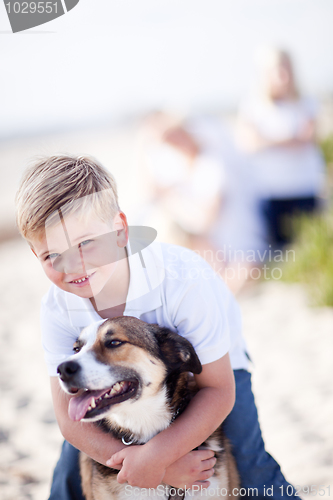 Image of Handsome Young Boy Playing with His Dog