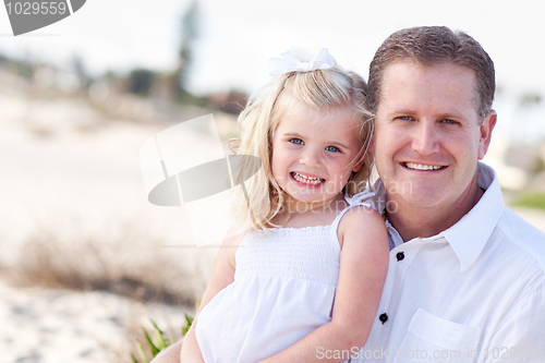 Image of Cute Daughter Cuddles up with Her at the Beach