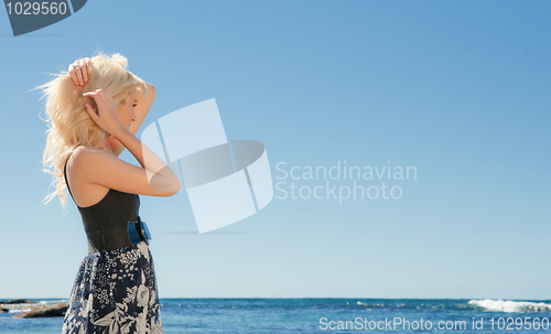 Image of young woman on reef at sea