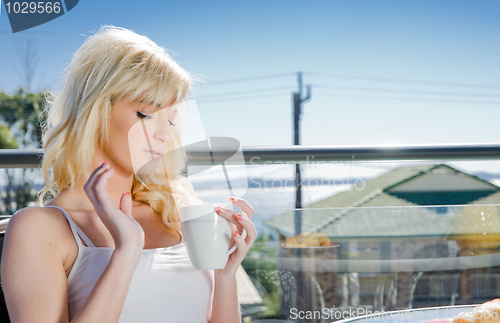 Image of beautiful woman having coffee in cafe