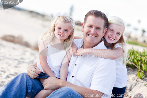 Image of Handsome Dad and His Cute Daughters at The Beach