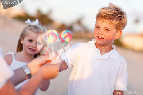 Image of Cute Brother and Sister Picking out Lollipop