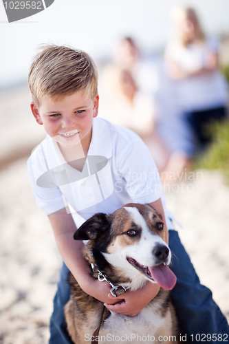 Image of Handsome Young Boy Playing with His Dog