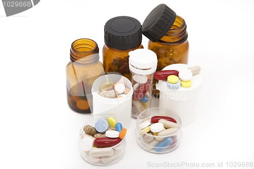 Image of colored stream of pills and pill bottles