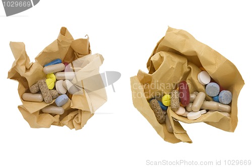 Image of colored pills and crumpled paper 