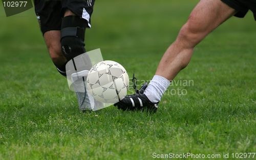 Image of Two men playing soccer