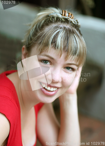 Image of Smiling blond girl in red