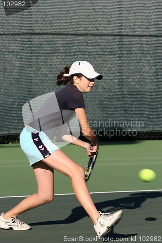 Image of Young girl playing tennis