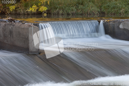 Image of old river dam with falling water