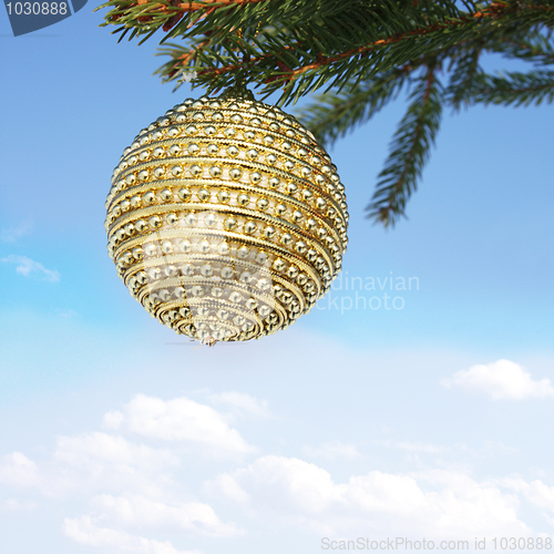 Image of christmas bauble and blue sky
