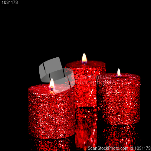 Image of Three spangled candles in the dark