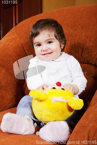 Image of Smiling baby girl with toy